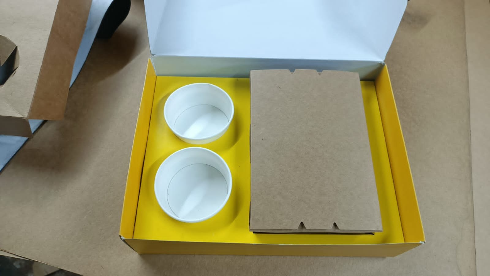 Open yellow Backstreet Kitchens meal box with two sauce containers