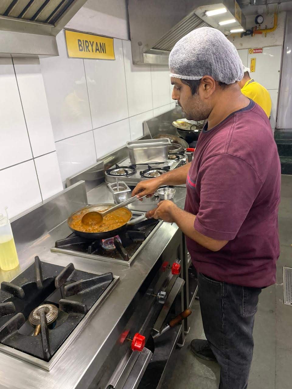 Chef cooking at a stove in the Backstreet Kitchens commercial kitchen